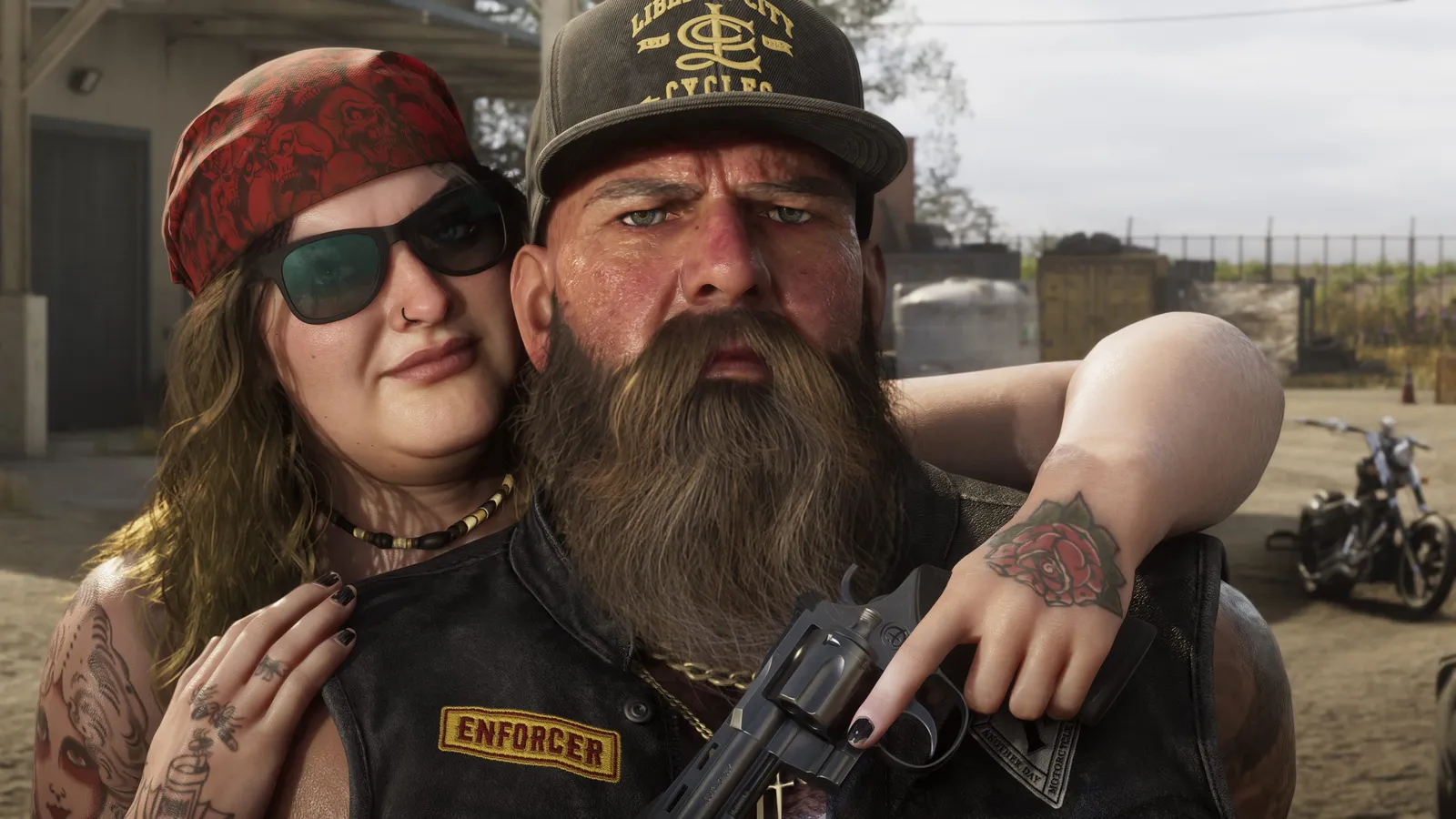 A bearded biker in an Enforcer-patch vest and a woman in a red bandana and sunglasses pose in Ambrosia