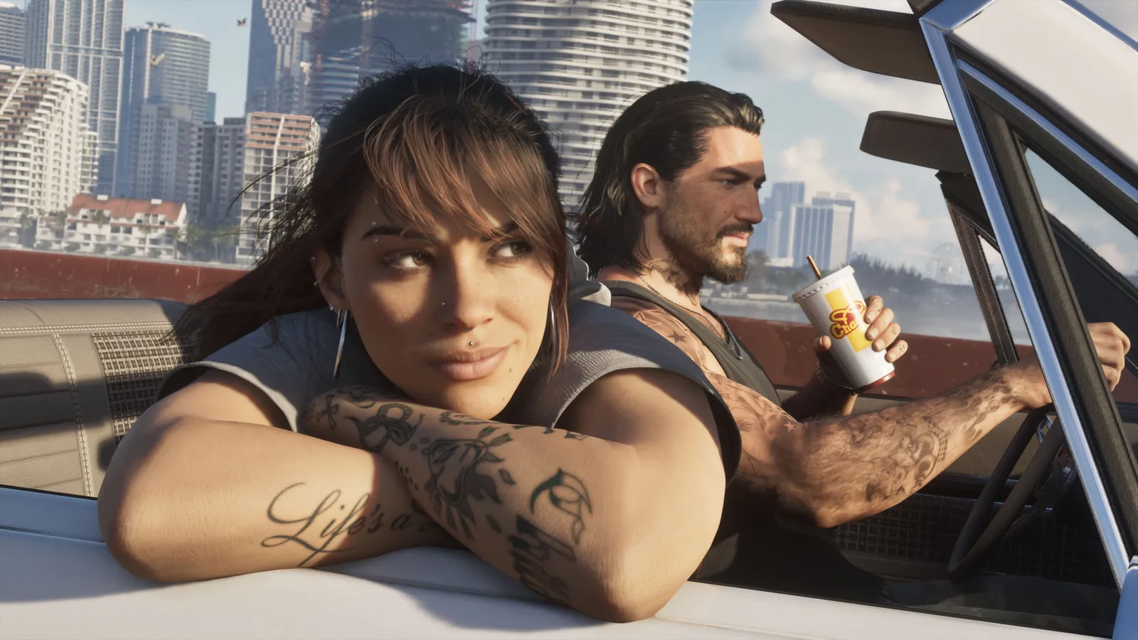 Lucia leans her tattooed arms on the window of a car while Jason drives with a drink in his hand, Vice City towers behind them