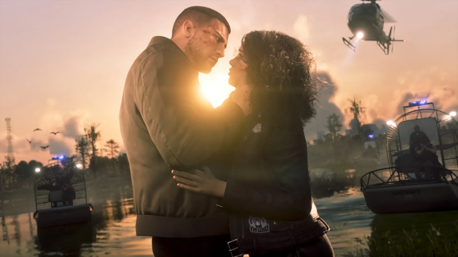 Jason and Lucia embrace at sunset in a swamp as police airboats with flashing lights and a helicopter close in
