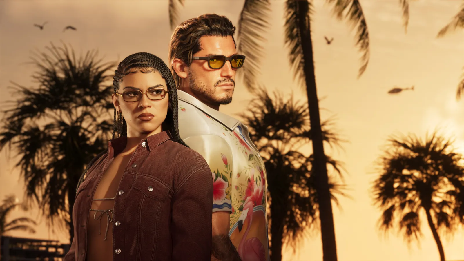 Lucia and Jason at sunset among palm trees, Jason in sunglasses and a floral shirt